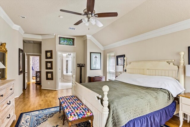 bedroom with lofted ceiling, hardwood / wood-style floors, ceiling fan, and connected bathroom