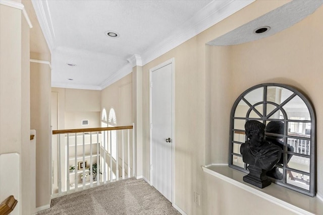 hallway with ornamental molding and carpet flooring