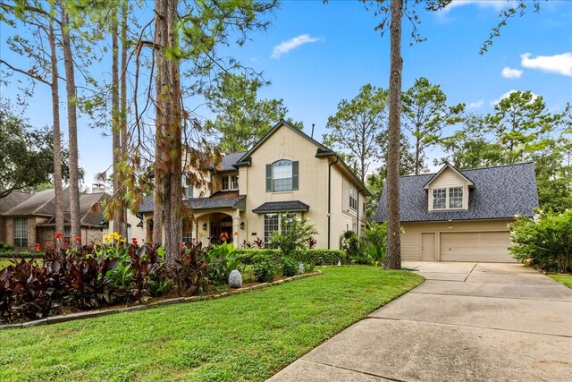 view of front of house with a garage and a front lawn