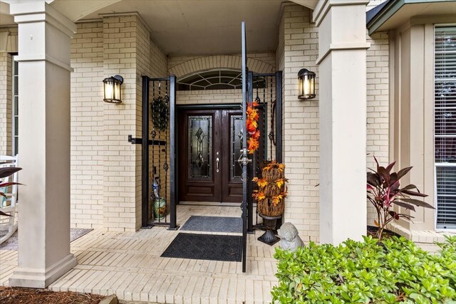 view of exterior entry with brick siding