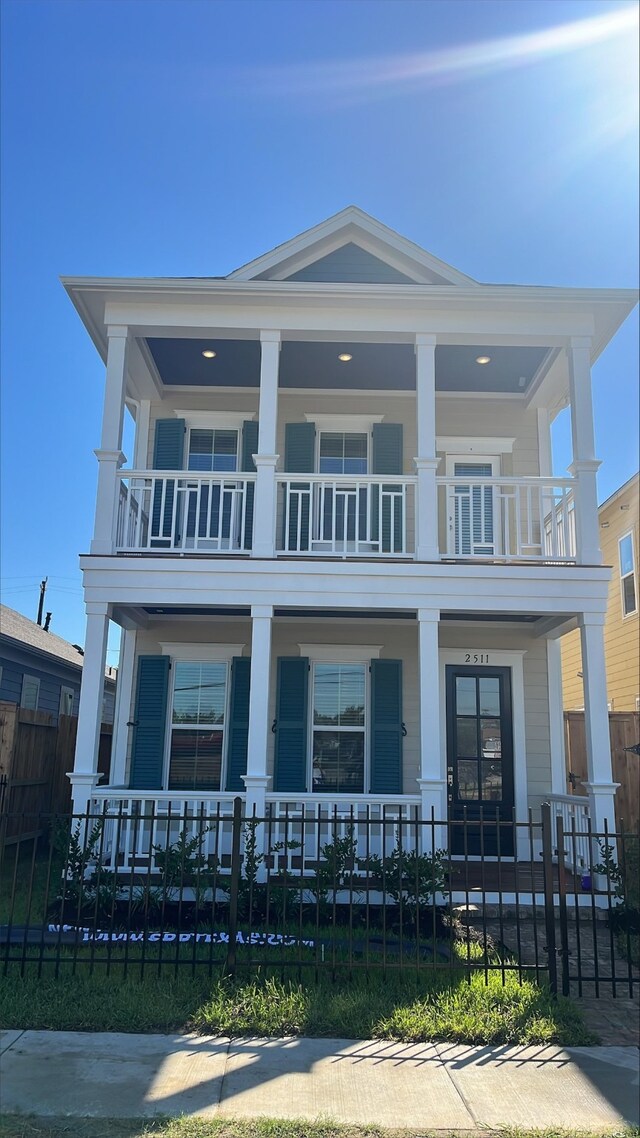 view of front of property featuring a balcony and covered porch