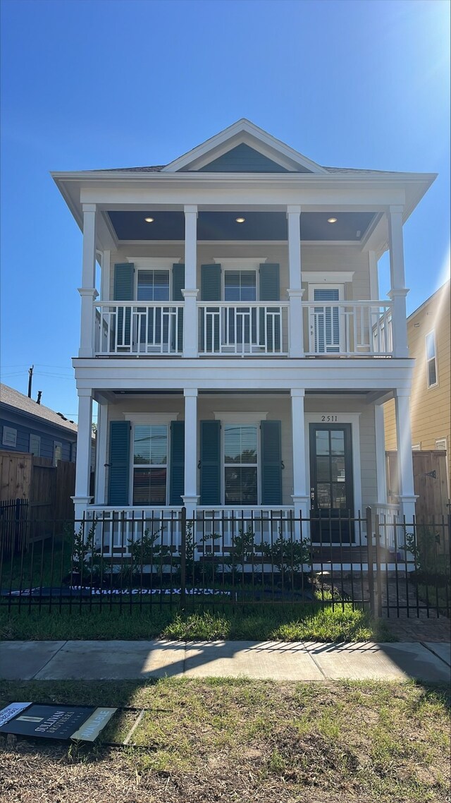 view of front of property with a balcony and a porch