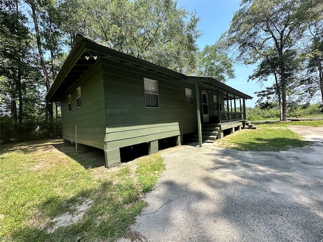 view of property exterior featuring covered porch