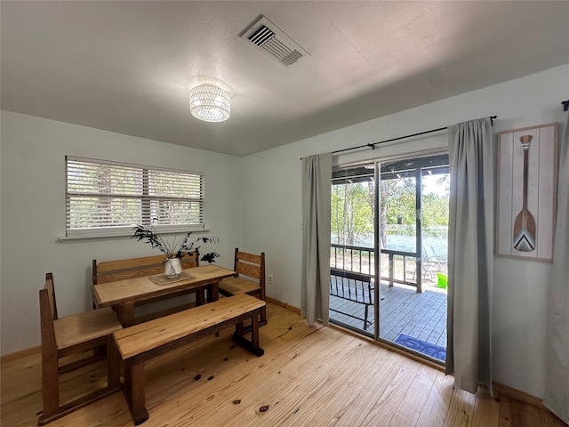 dining space with light hardwood / wood-style floors