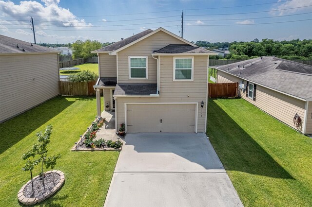 view of front of home featuring a garage and a front yard