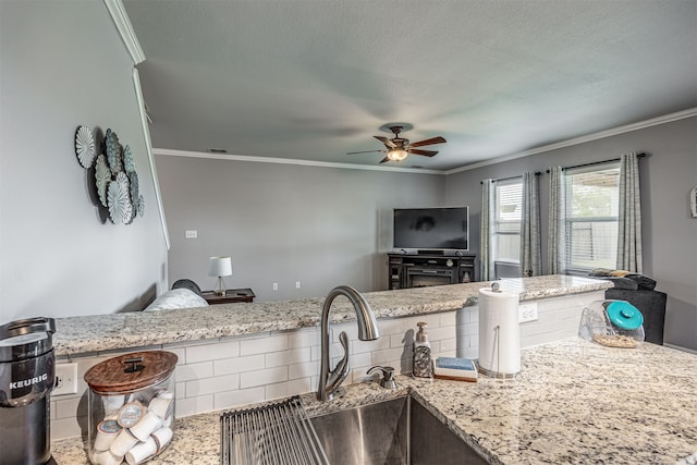 kitchen featuring tile patterned floors, light stone countertops, sink, and ceiling fan