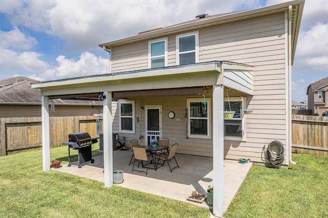 rear view of property featuring a patio area and a lawn