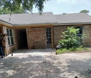 back of house featuring brick siding