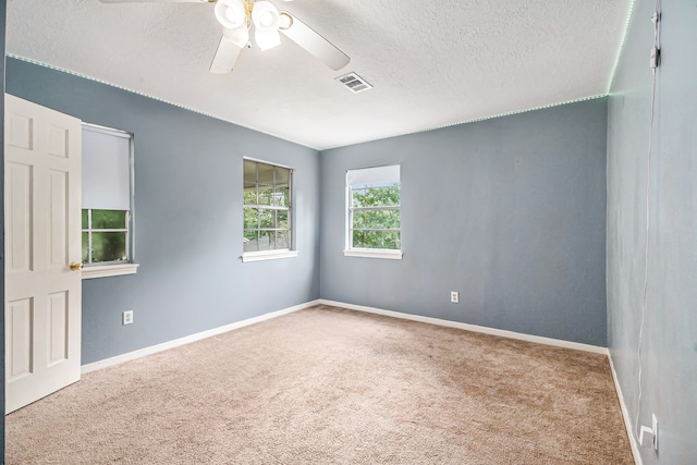 unfurnished room with light carpet, a textured ceiling, and ceiling fan