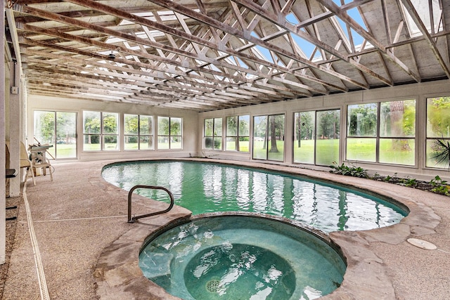 view of swimming pool with an indoor hot tub