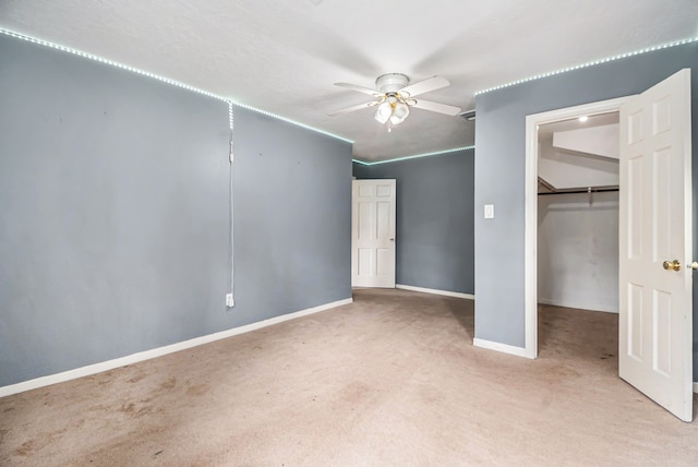 interior space with a closet, ceiling fan, and light colored carpet