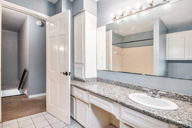 bathroom with tile patterned floors and vanity