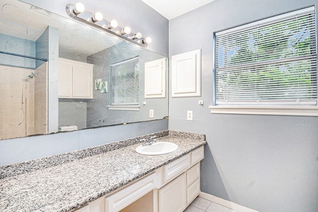 bathroom with vanity, tile patterned floors, and toilet