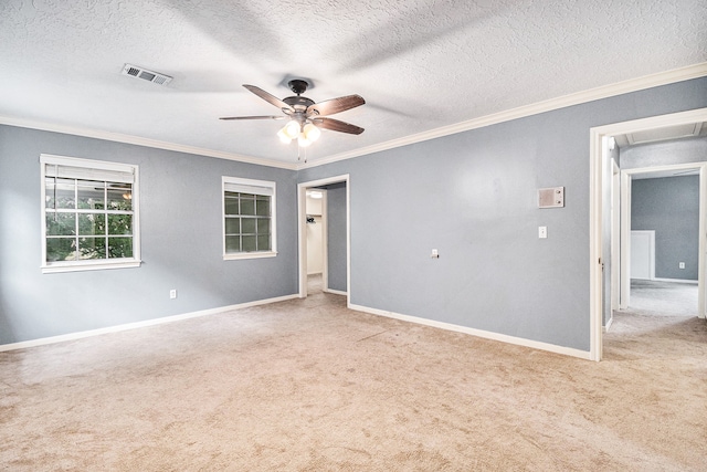 carpeted spare room with a textured ceiling, ceiling fan, and ornamental molding