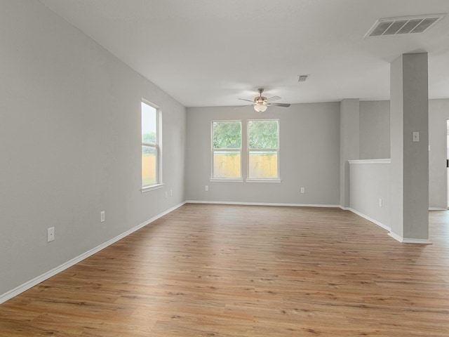 empty room with ceiling fan and light hardwood / wood-style floors