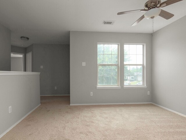 unfurnished room with ceiling fan and light carpet