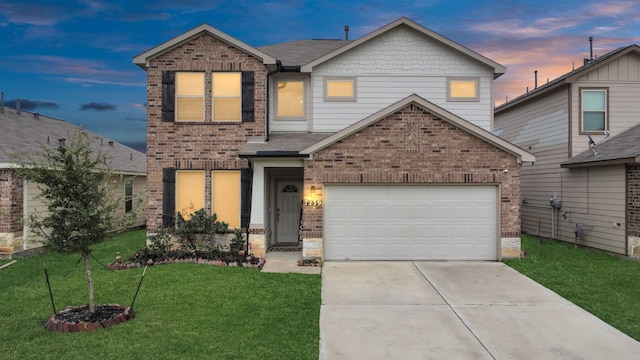 view of front of property with a garage and a yard