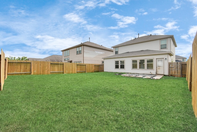 rear view of property with a yard