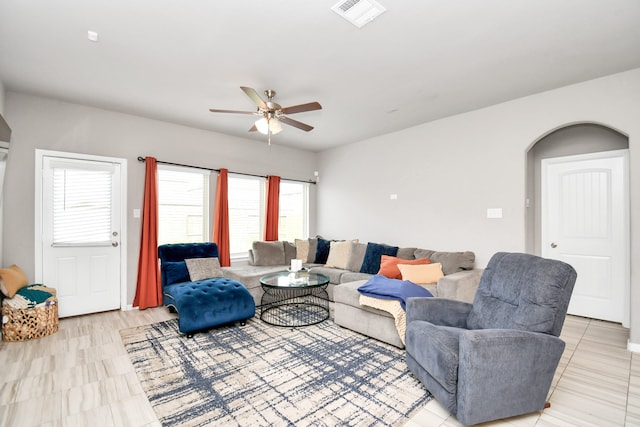 tiled living room with ceiling fan