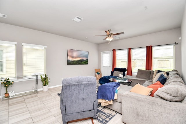 tiled living room featuring a healthy amount of sunlight and ceiling fan