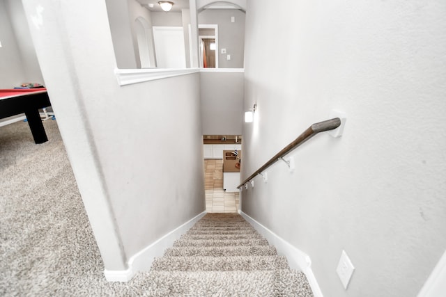 stairway with tile patterned floors