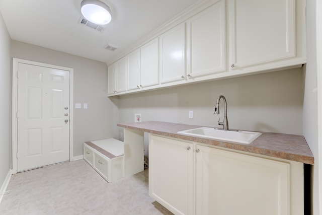 clothes washing area with sink, washer hookup, and light tile patterned floors