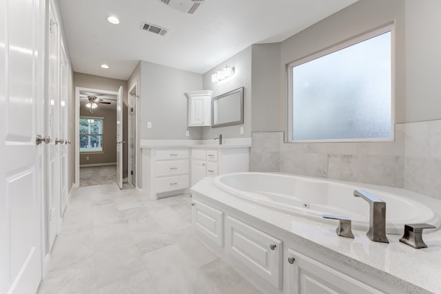 bathroom with vanity, a tub to relax in, ceiling fan, and tile patterned flooring