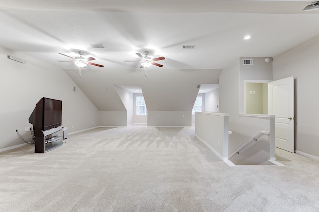 additional living space featuring lofted ceiling, light colored carpet, and ceiling fan