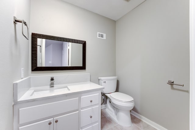 bathroom with vanity, tile patterned flooring, and toilet