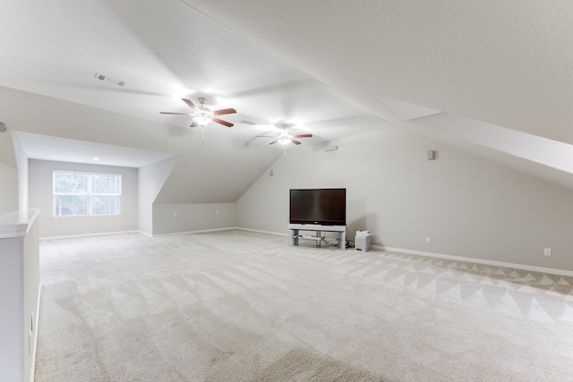 bonus room with light carpet, vaulted ceiling, a textured ceiling, and ceiling fan