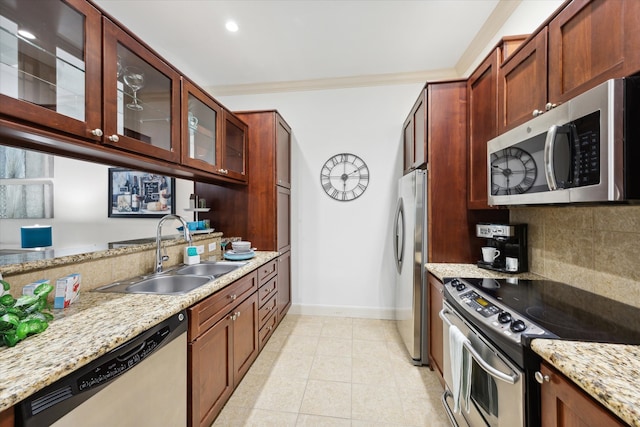 kitchen featuring stainless steel appliances, sink, backsplash, light tile patterned floors, and light stone countertops