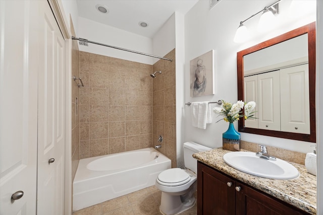 full bathroom featuring vanity, tiled shower / bath combo, toilet, and tile patterned floors