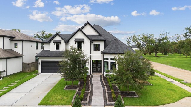 view of front of property featuring a garage and a front lawn