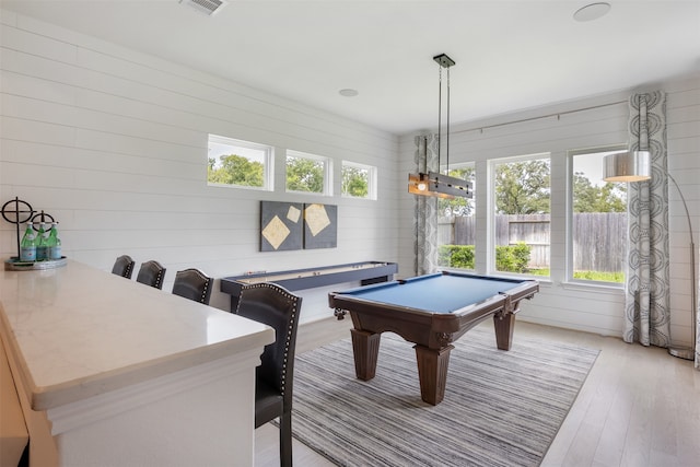 recreation room featuring pool table, light hardwood / wood-style flooring, and wooden walls