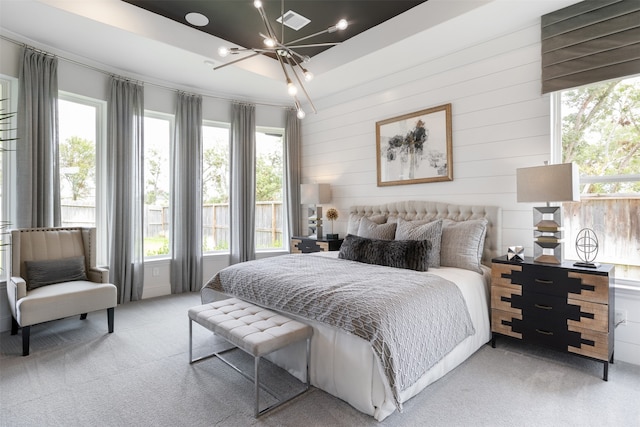 bedroom featuring multiple windows and light carpet