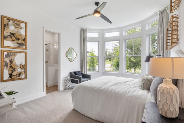 bedroom featuring connected bathroom and ceiling fan