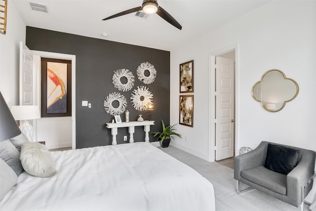 bedroom featuring light colored carpet and ceiling fan