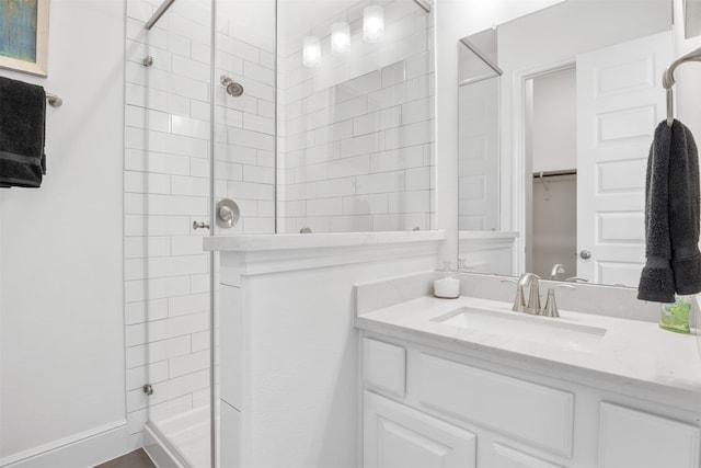 bathroom with vanity and a tile shower