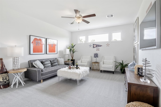 carpeted living room featuring ceiling fan