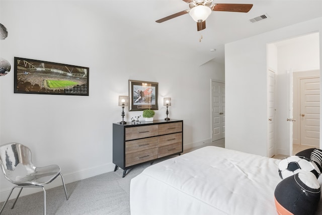 bedroom with carpet floors, ceiling fan, and connected bathroom