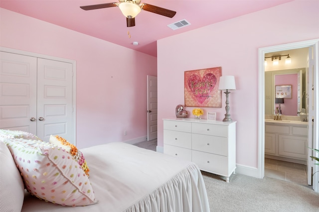 tiled bedroom featuring sink, a closet, connected bathroom, and ceiling fan