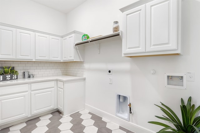 laundry area with cabinets, light tile patterned floors, hookup for an electric dryer, gas dryer hookup, and washer hookup