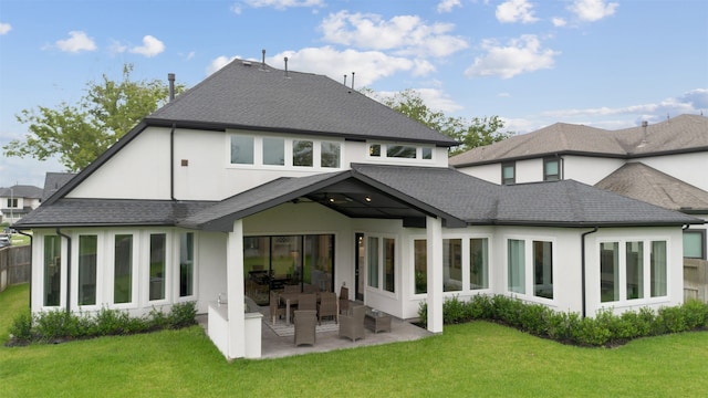 rear view of house featuring a patio and a lawn