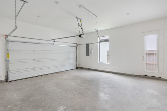 garage featuring a garage door opener and electric panel