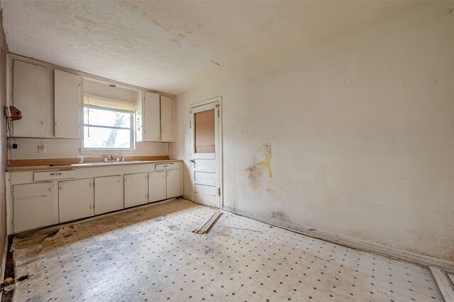 kitchen with light tile patterned flooring and a textured ceiling