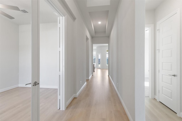 hallway with light hardwood / wood-style floors