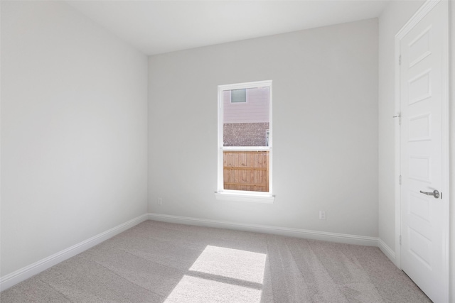 spare room featuring light colored carpet