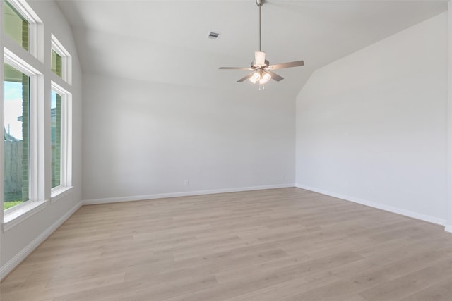 spare room featuring ceiling fan, vaulted ceiling, and light hardwood / wood-style flooring