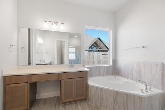 bathroom featuring vanity and shower with separate bathtub