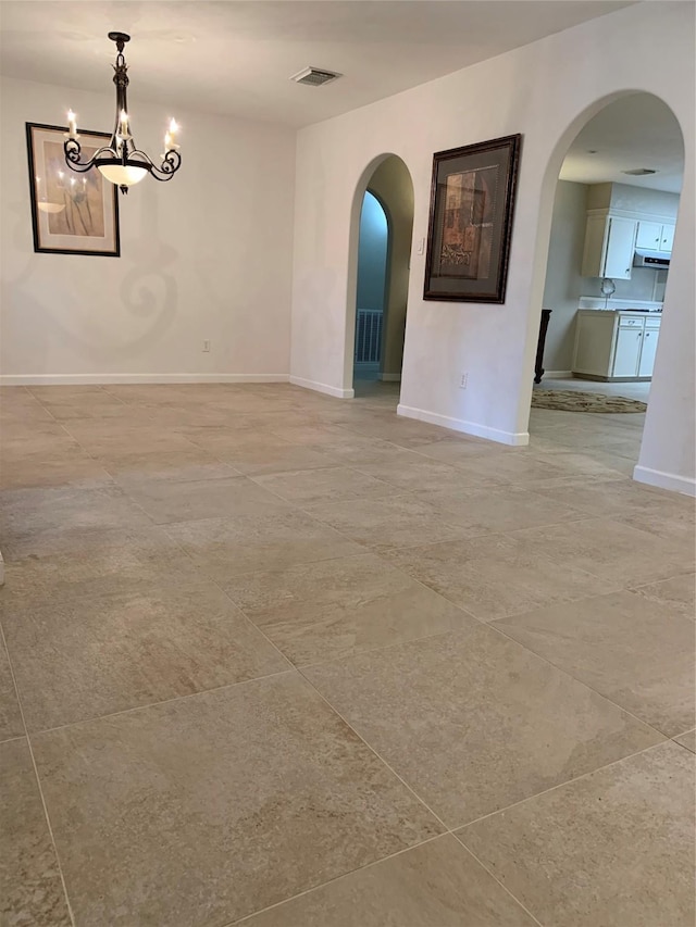 411 Sailfish St, Jones Creek, TX 77541 - unfurnished room featuring arched walkways and a chandelier